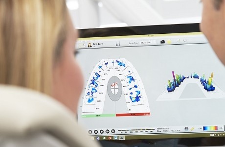 Dentist looking at a screen showing detailed scans of their teeth