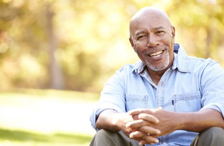Smiling man sitting outside
