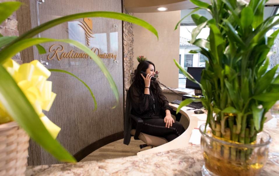 Front desk receptionist talking on phone