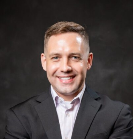 Smiling man in black suit jacket