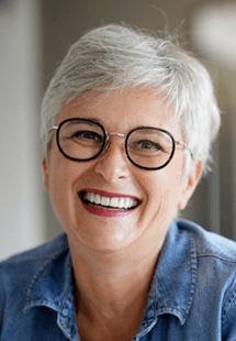 older woman smiling with glasses