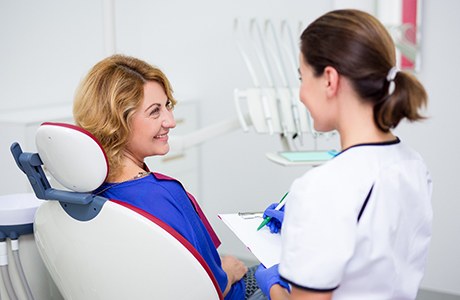 Woman talking with dental team member during consultation