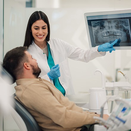 Dentist and patient reviewing X-ray together