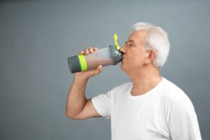 Older man enjoying a protein shake 