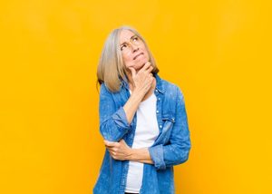 Mature woman wearing curious, thoughtful expression